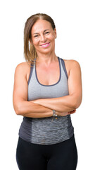 Beautiful middle age woman wearing sport clothes over isolated background happy face smiling with...