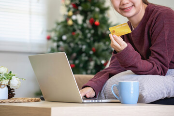 Beautiful Asian women using credit cards for shopping online with laptops and smartphones, online shopping portrait concept.