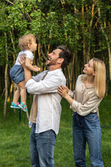 Cute young couple with their baby looking happy