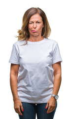 Obraz premium Middle age senior hispanic woman over isolated background skeptic and nervous, frowning upset because of problem. Negative person.