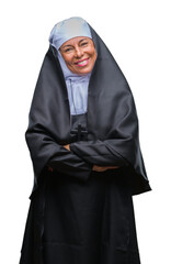Middle age senior christian catholic nun woman over isolated background happy face smiling with...