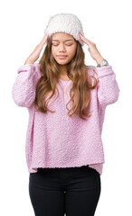 Young beautiful brunette woman wearing sweater and winter hat over isolated background with hand on head for pain in head because stress. Suffering migraine.