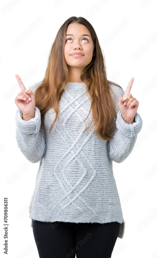 Sticker young beautiful brunette woman wearing sweater over isolated background amazed and surprised looking