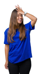Young beautiful brunette woman wearing blue t-shirt over isolated background surprised with hand on...