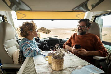 Couple enjoys the weekend aboard their camper. Happy man together with his wife spending pleasant...