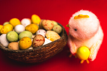 Fototapeta na wymiar Easter Charm: A Plush Chick and Its Colorful Bounty