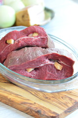 Raw beef on a cutting board ready to be cooked in the oven