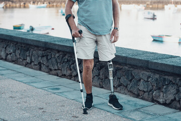 a full member of society an elderly man with a titanium prosthetic left leg walks smoothly in a...