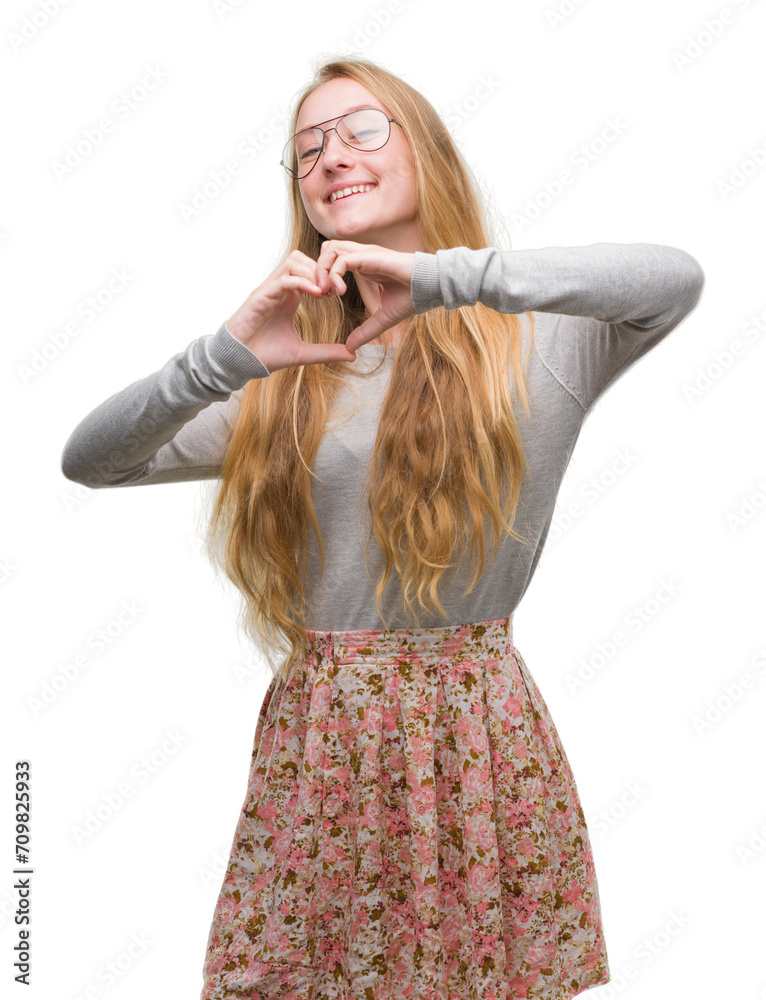 Sticker Blonde teenager woman wearing flowers skirt smiling in love showing heart symbol and shape with hands. Romantic concept.