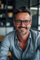 Male boss smiling with glasses in office