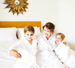 Obraz premium Happy mother and daughters doing selfie