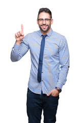 Young business man wearing glasses over isolated background showing and pointing up with finger number one while smiling confident and happy.