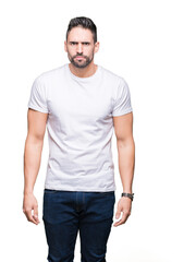 Fototapeta premium Young man wearing casual white t-shirt over isolated background skeptic and nervous, frowning upset because of problem. Negative person.