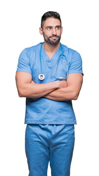 Handsome young doctor surgeon man over isolated background smiling looking side and staring away thinking.