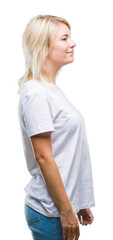 Young beautiful blonde woman wearing white t-shirt over isolated background looking to side, relax profile pose with natural face with confident smile.