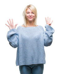 Young beautiful blonde woman wearing winter sweater over isolated background showing and pointing...