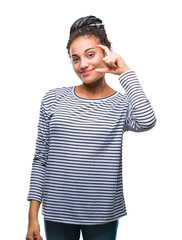 Young braided hair african american girl wearing sweater over isolated background smiling and confident gesturing with hand doing size sign with fingers while looking and the camera. Measure concept.