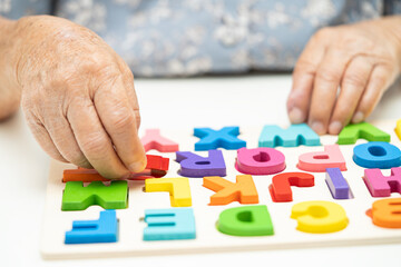 Alzheimer disease AD, Asian elderly woman patient suffering from dementia learn practical motor...