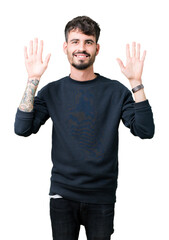 Young handsome man over isolated background showing and pointing up with fingers number ten while smiling confident and happy.
