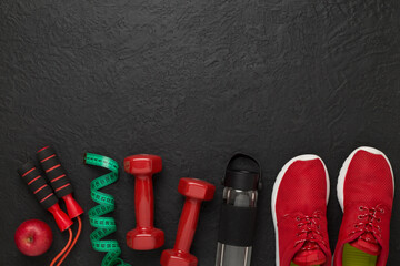 Sport equipment with tape measure on concrete background, top, view. Weight loss concept