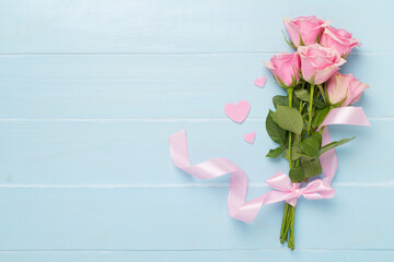 Pink roses with hearts on wooden background, top view. Valentines day concept