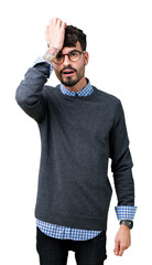 Young handsome smart man wearing glasses over isolated background surprised with hand on head for...