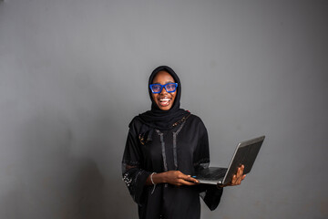 beautiful and stylish african lady using her laptop computer