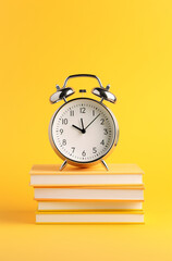 alarm clock on books on yellow background, illustration minimalism for business book created with Generative Ai
