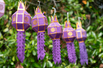 Selective focus of violet Yi Peng lanterns.

