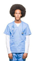 Young african american doctor man with afro hair Relaxed with serious expression on face. Simple and natural looking at the camera.