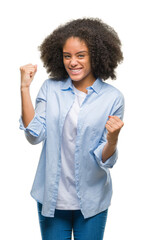 Young afro american woman over isolated background very happy and excited doing winner gesture with...