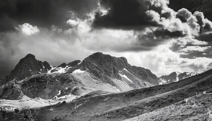Fototapeta premium Minimalist mountain landscape with dramatic sky; black and white image