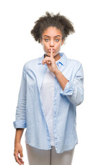 Young afro american woman over isolated background asking to be quiet with finger on lips. Silence and secret concept.