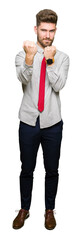 Obraz premium Young handsome business man Ready to fight with fist defense gesture, angry and upset face, afraid of problem