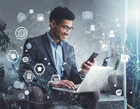Internet of Things IoT, digital marketing, E-commerce, global business concept. Man using mobile phone and laptop computer with digital technology