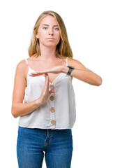 Beautiful young woman over isolated background Doing time out gesture with hands, frustrated and...