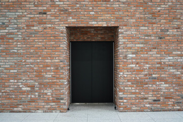 wall made of bricks and a door installed in the center