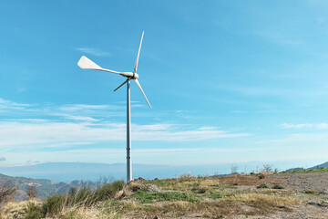 Green energy concept. Мountain top industrial wind power plant, wind turbine for generation electricity in wind farm or wind park.