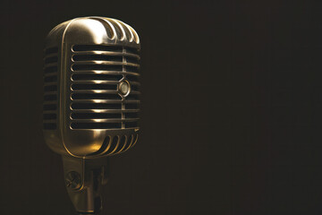 Naklejka premium retro microphone on a black background