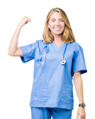 Beautiful young doctor woman wearing medical uniform over isolated background Strong person showing arm muscle, confident and proud of power