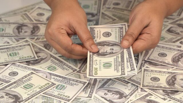 close-up of hundred dollar bills, slow motion