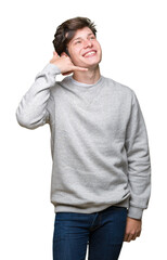 Young handsome sporty man wearing sweatshirt over isolated background smiling doing phone gesture with hand and fingers like talking on the telephone. Communicating concepts.