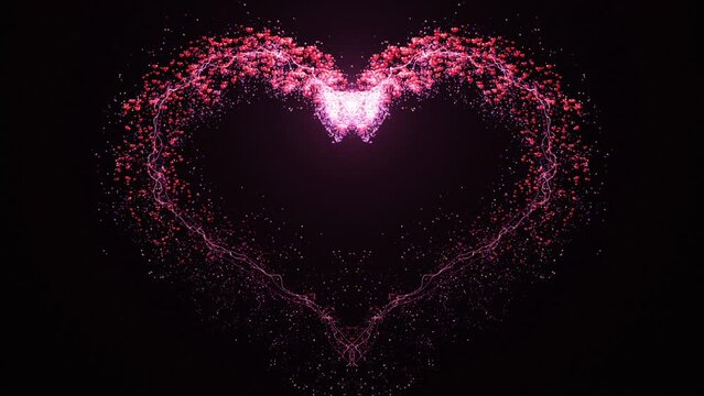 This motion stock graphic shows the forming of a pink particle heart on a black background.