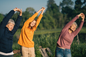 A Gay lesbian retired couple is doing yoga or exercising in the early morning with their grandchild...