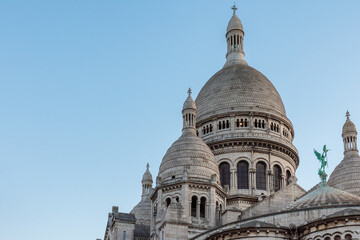Fototapeta premium Dome of Basilica of Sacre Coeur de Montmartre, Paris, France at sunset. Roman Catholic church Sacred Heart. Famous landmark. Popular travel destination
