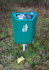 Fully loaded trash bin in the forest