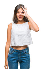 Young asian woman over isolated background doing ok gesture with hand smiling, eye looking through fingers with happy face.