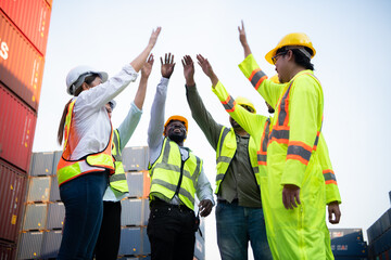 A group of happy team workers stood hand in hand to show their strength and power to start work, In the container storage yard