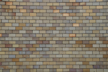 Wall of ceramic blocks aligned with cement joints forming a background texture.
