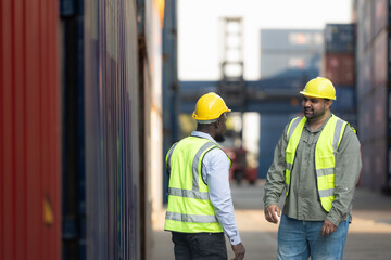 Both of workers in a container storage yard greeting each other during breaks in front of container...